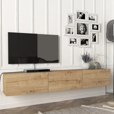 A modern living room setup with a wall-mounted TV and a wooden media console.