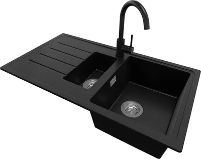 A black double basin kitchen sink with a black faucet and a draining board, isolated on a white background.