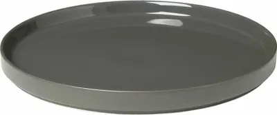 A close-up, angled view of a single, dark gray ceramic plate against a white background.