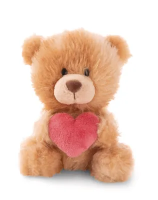 A light brown teddy bear with a pink heart is sitting and facing the camera against a white background.