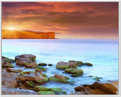 Produktbild von Wallario Wandbild Sonnenaufgang am Meer mit Landzunge und Felsen im Wasser, Größe: 40,30 x 50,30 cm, Poster mit weißem Aluminiumrahmen