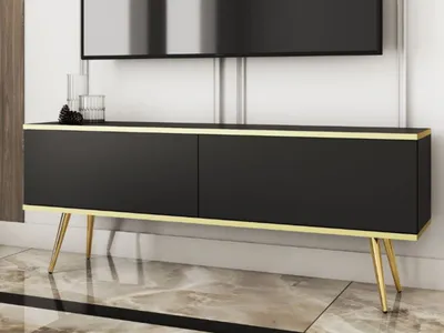 A black TV stand with gold accents and legs, placed in a modern living room setting.