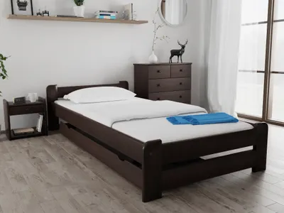 A bedroom with a bed, nightstand, and dresser.