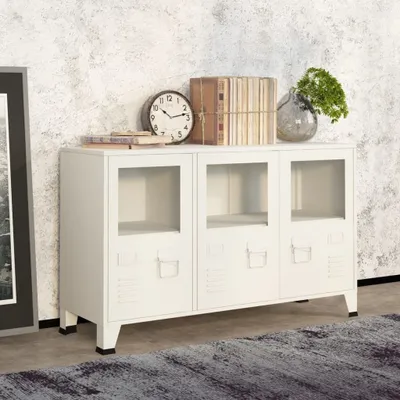 A white industrial-style sideboard with glass doors, decorated with books, a clock, and a vase with greenery, placed against a textured wall.
