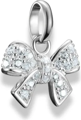 A close-up studio shot of a silver bow-shaped charm encrusted with small clear stones, suspended from a silver loop.