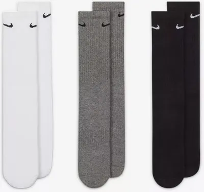 Three pairs of Nike socks in different colors (white, gray, and black) are laid out side-by-side.