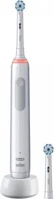 A white electric toothbrush and a replacement brush head on a white charging base, all against a white background.