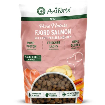 A bag of dog food with images of salmon, potatoes, and carrots.