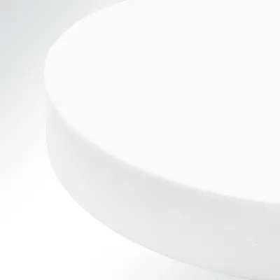 A close-up, abstract view of a white circular object, likely a sound-absorbing panel, against a gradient white and light gray background.