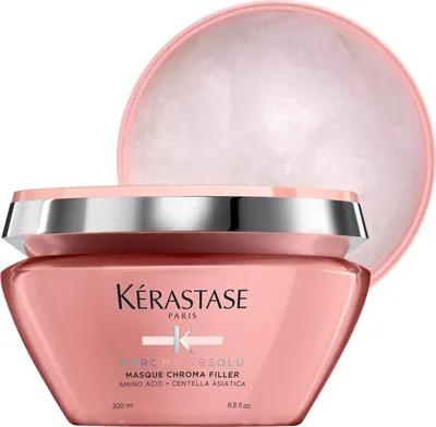 A pink jar of Kerastase hair mask with its lid slightly ajar.