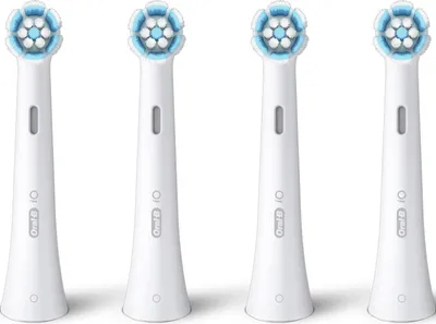 Four white Oral-B iO toothbrush heads are arranged in a row against a white background.