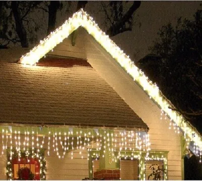 A house decorated with Christmas lights at night.