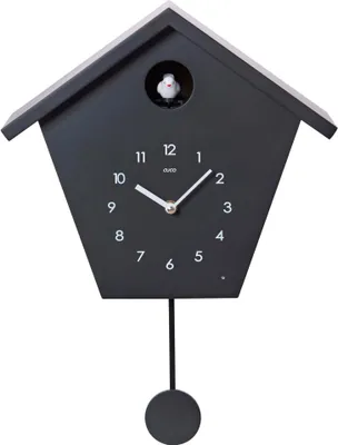 A black cuckoo clock with a pendulum and a small bird visible in the upper window.
