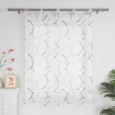 A sheer curtain with a modern abstract pattern hangs on a curtain rod against a white wall.
