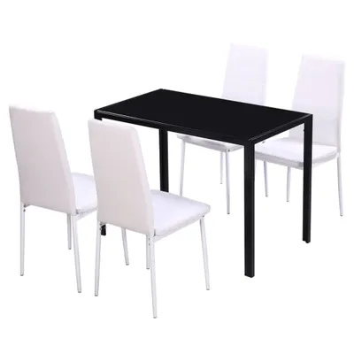 A black dining table with four white chairs.