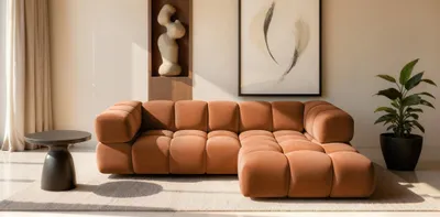 Productafbeelding van Designbank BLANCHE, model hoekbank, bekleed met stof Bluvel in de kleur roestbruin. Inclusief ottoman (voetbank) aan de rechterkant