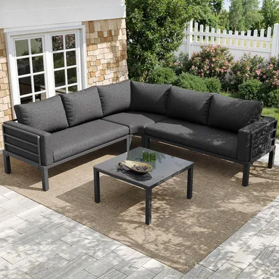 An outdoor patio setting with a sectional sofa and coffee table.