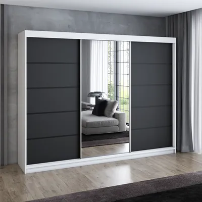 A modern sliding door wardrobe with mirrored doors, set against a concrete wall.