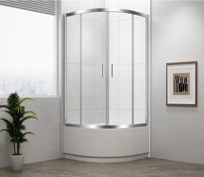 A modern bathroom with a curved glass shower enclosure and a potted plant.