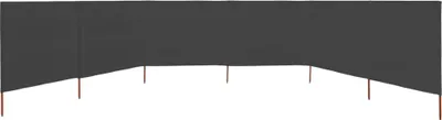 A dark grey windbreak fabric with brown stakes supporting it.