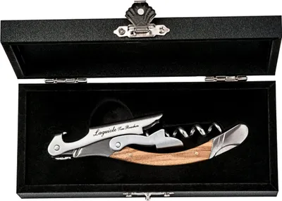 A Laguiole corkscrew with a wooden handle is displayed in an open black box.
