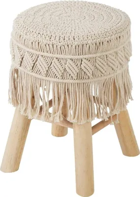 A round stool with a macrame cover and wooden legs against a white background.