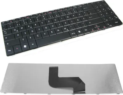 A laptop keyboard and its detached metal base with a ribbon cable.