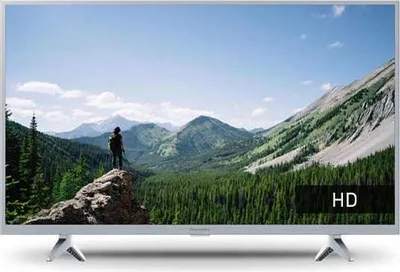 A television displaying a scenic mountain landscape with a person standing on a rock.