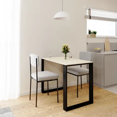 A small dining table with two chairs in a modern kitchen setting.