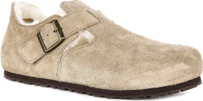 A single taupe Birkenstock shoe with sherling lining is shown from a side angle against a white background.