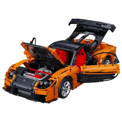 A detailed model of an orange sports car with its hood, doors, and rear spoiler open, revealing the engine and interior.