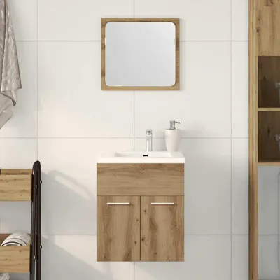A bathroom vanity set with a mirror and sink against a tiled wall.