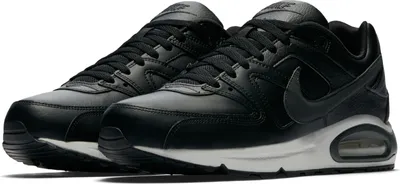 A pair of black Nike Air Max Command leather sneakers.