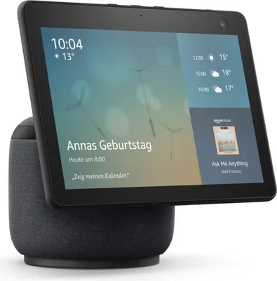 An Amazon Echo Show 10 smart display with a dark gray fabric base, showing a personalized greeting and weather information.