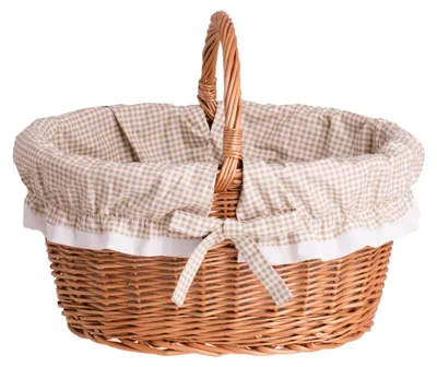 A wicker basket with a checkered lining and a bow.