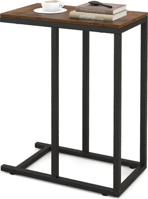 A C-shaped side table with a rustic brown top and black metal frame, shown against a white background. A cup of coffee and two books are placed on the tabletop.