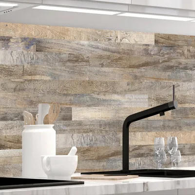 A close-up view of a kitchen backsplash with a wood plank design, featuring kitchenware and a faucet.