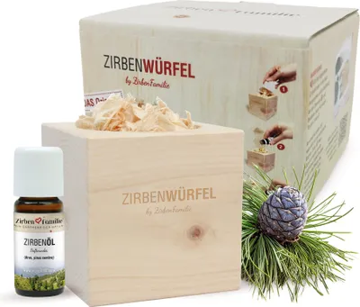 A set of Zirbenwürfel (pine wood cubes) with essential oil and a pine cone.