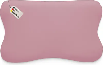 A pink pillow with a tag indicating it is made in Germany.