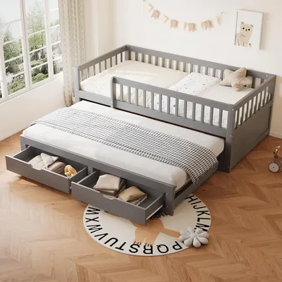 A gray daybed with a pull-out trundle bed and storage drawers, set in a child's bedroom with a window and decorative garland.