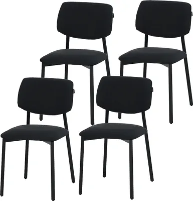 A set of four black dining chairs arranged in a staggered formation against a white background.