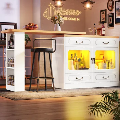 A modern kitchen or dining area with a bar table, stools, and decorative elements.