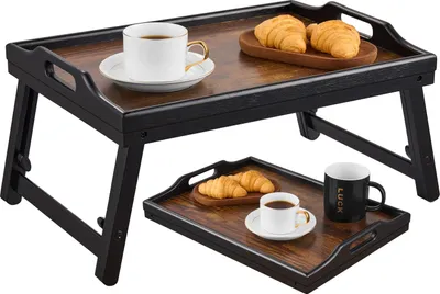 Two breakfast trays with coffee and croissants are displayed.