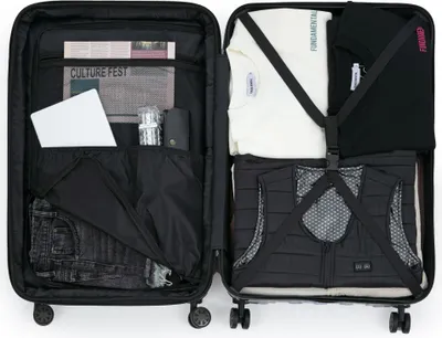 An open suitcase with clothes and items packed inside.