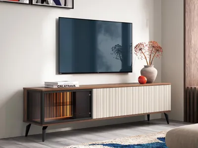 A TV stand with a television mounted above it, in a well-lit room.