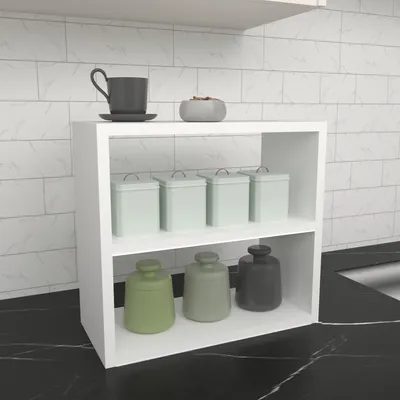 A white shelf with kitchen canisters and a mug on a marble countertop.