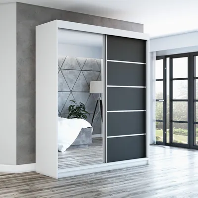 A modern bedroom with a large sliding door wardrobe with mirrored doors and dark gray panels.