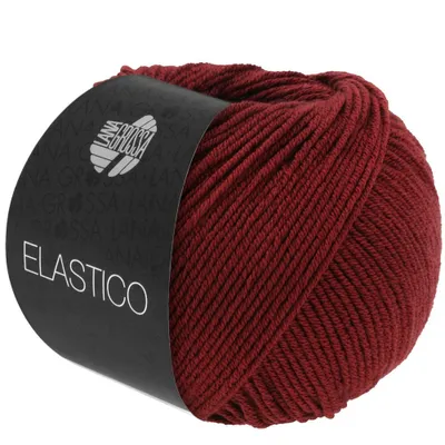 A ball of red yarn with a black label wrapped around it.