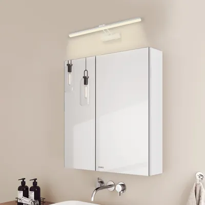 A modern bathroom vanity with a mirrored cabinet and integrated lighting.
