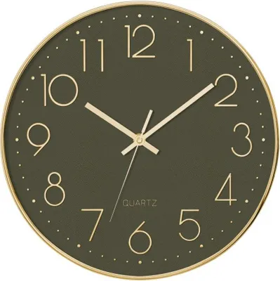 A close-up view of a wall clock with a dark green face and gold numbers and hands.